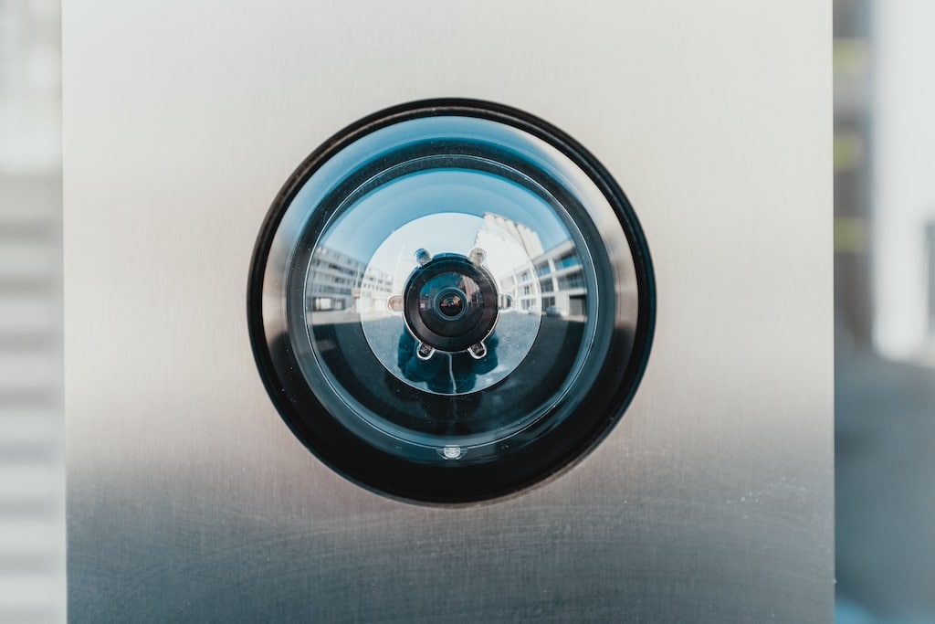 A circular security camera lens, shining and clean